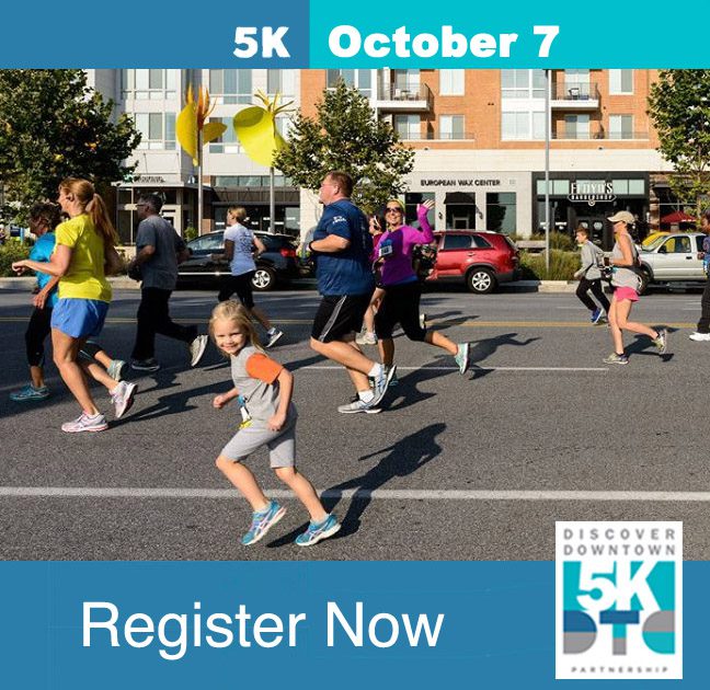A group of people running in the street.