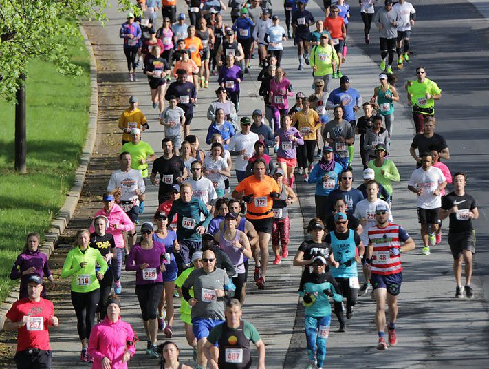 A large group of people running on the road.