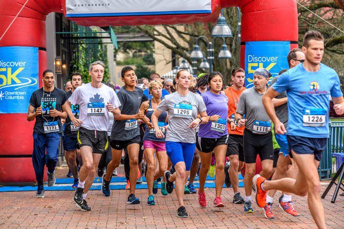 A group of people running in the street