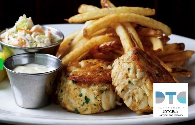 Crab cakes and french fries on a plate.